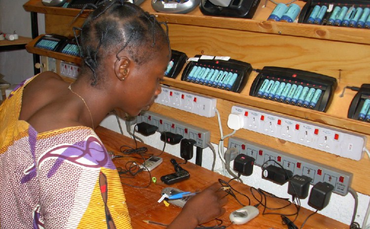 A villager in Garoua-Boulai, Cameroon charges phones at a solar power station