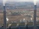 Smoking stacks of an Eskom power station. In the background is a human settlement, in close proximity to the power station and its air pollution. Photo: Melissa Fourie/CER