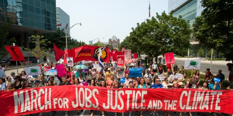 Thousands march through downtown Toronto during the Jobs, Justice & the Climate March on July 5th, 2015. The march was led by First Nations followed by frontline, impacted communities from across Toronto and beyond. The people were marching to call for action on climate change.