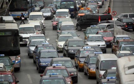 Bumper to bumper traffic at an intersection in central Beijing.  Beijing is notorious for its smog and is rapidly earning the distinction of having the highest vehicular pollution in the world.  Particulate emissions from cars now account for nearly a quarter--an estimated 23.3 percent--of the city's total suspended particles.