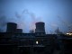 Chimneys of coal-fired power plant are seen next to residential houses in the night in Shijiazhuang, Hebei province, China,  January 28, 2015.  REUTERS/Kim Kyung-Hoon